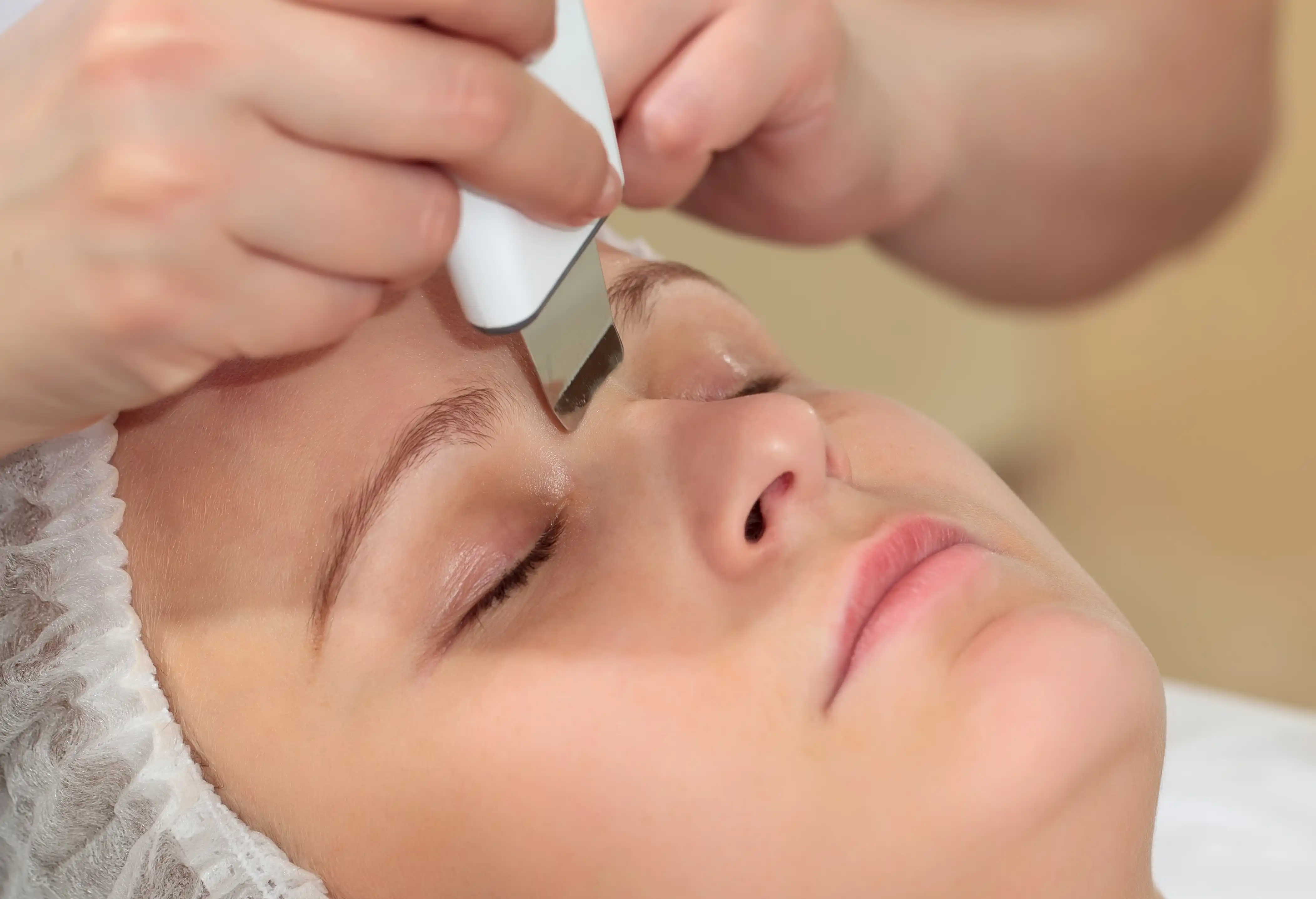 Licensed esthetician performing a deep cleansing facial treatment, demonstrating professional skincare expertise