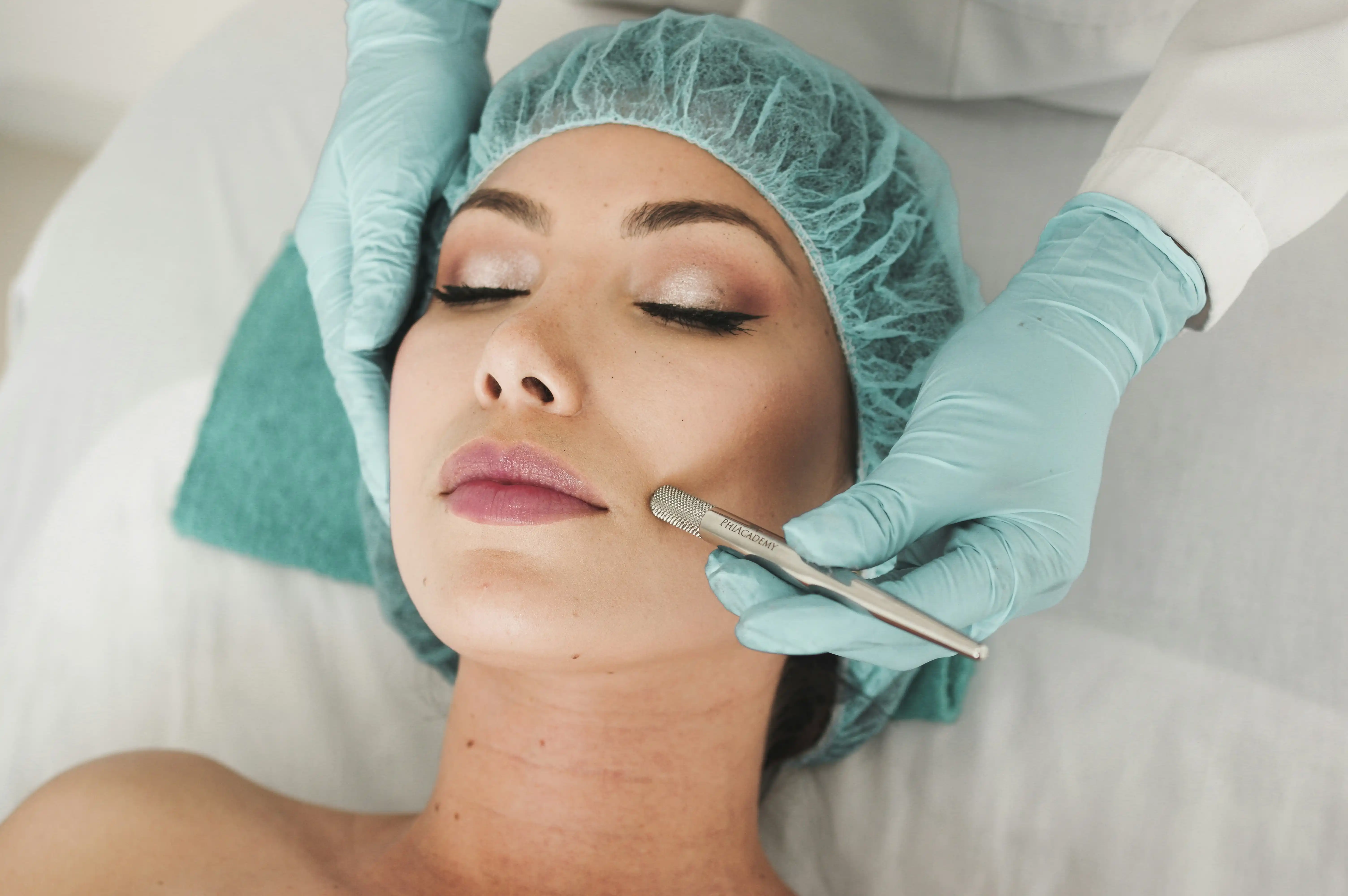 Esthetician performing dermaplaning with sterile blade in Oklahoma clinic