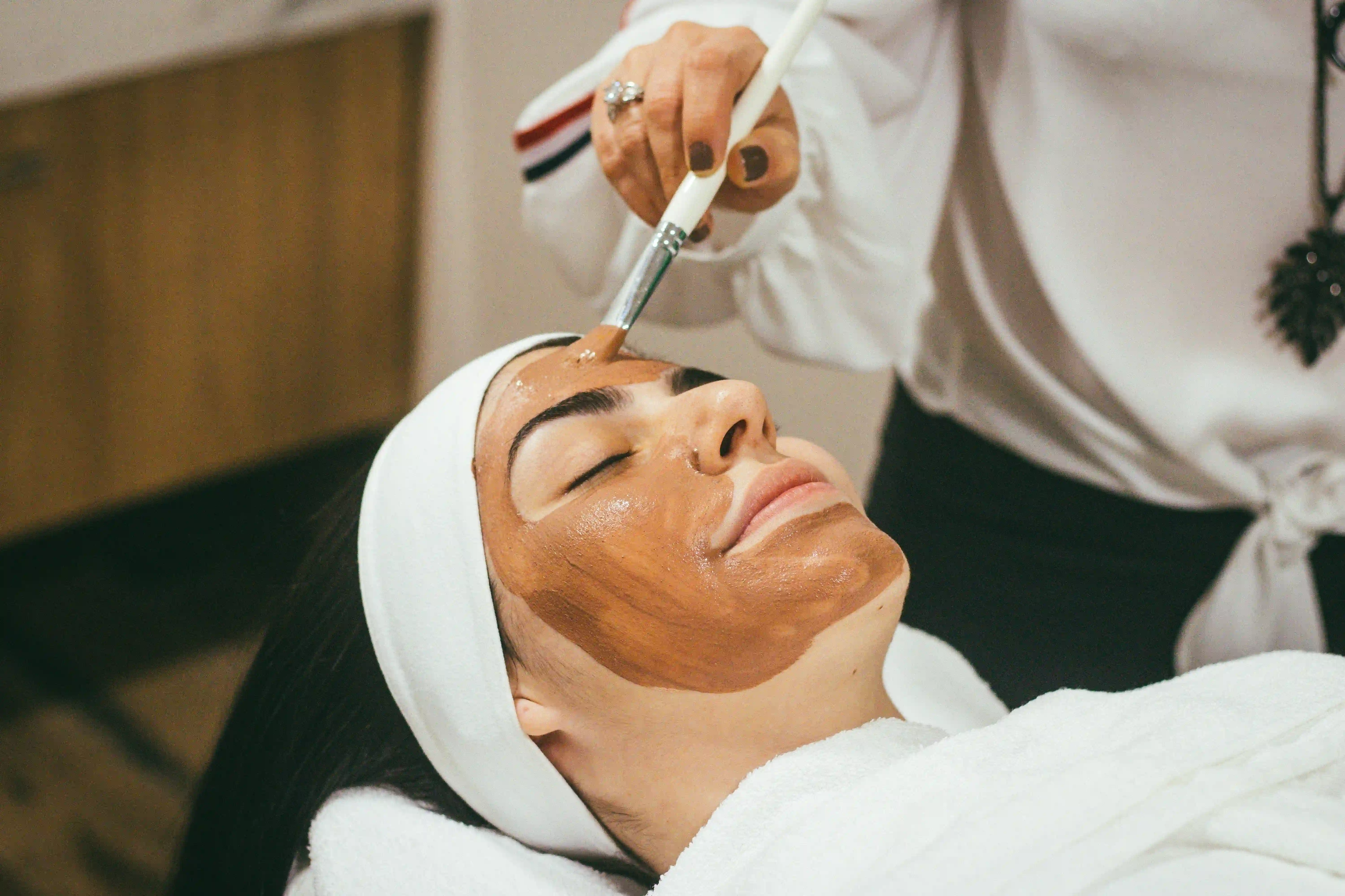 Client enjoying a relaxing facial treatment, demonstrating the importance of regular skincare maintenance